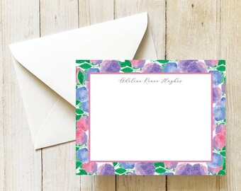 May include: A white card with a pink and purple floral border. The text "Adeline Rice Hayes" is printed in black cursive at the top of the card.