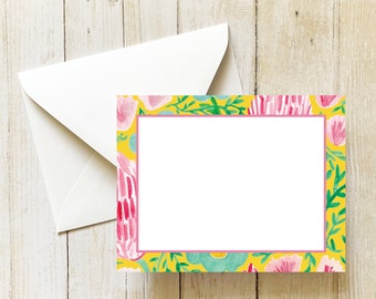May include: A yellow card with a pink floral border. The card has a white space in the center for writing a message.