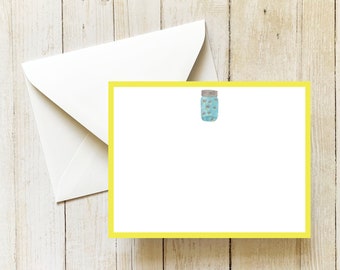 May include: A yellow card with a white border and a blue mason jar with a brown lid and a white background. The jar is filled with small white dots.