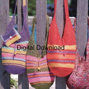 May include: Four crocheted bags hanging on a wooden fence. The bags are striped in various colors, including purple, red, green, and pink. The bags have a drawstring closure and are made with a textured yarn.