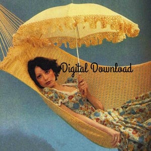 May include: A woman relaxes in a yellow crocheted hammock with a white crocheted parasol overhead. The hammock is suspended from two ropes and the woman is wearing a floral dress.