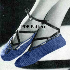 May include: A pair of blue knitted ballet slippers with black ribbon ties. The slippers have a white trim and are labeled "PDF Pattern". The slippers are designed to be worn on the feet.
