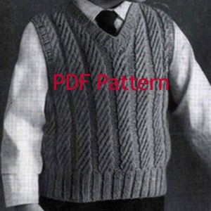 May include: A gray knitted vest with a cable knit pattern. The vest has a V-neck and is being worn over a white button-down shirt. The text "PDF Pattern" is printed on the vest.