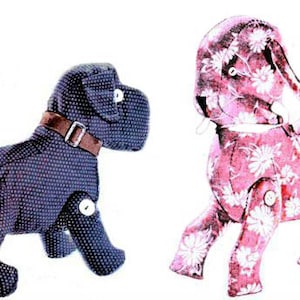May include: Two plush toy dogs. One is black with white polka dots and the other is pink with white floral print. Both dogs have button eyes and are articulated at the joints.