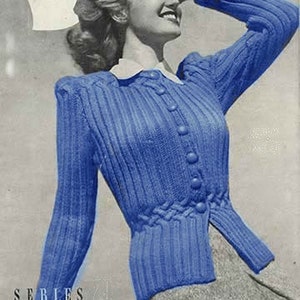 May include: A blue knitted cardigan with a cable knit detail on the front and a button closure. The cardigan is worn by a woman with her hair styled in a vintage updo. The image is from a vintage knitting book.