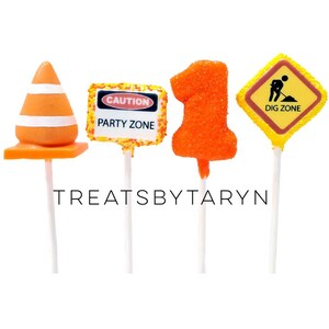 May include: Four construction-themed cake pops. One is a cone, one is a sign that says "Caution Party Zone", one is a number "1", and one is a sign that says "Dig Zone".