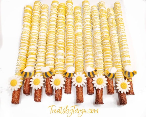 Chocolate Covered Pretzels. Daisy pretzels. pretzels. baby shower pretzel rods. Bumble bee rods. Daisy pretzels. Bee treat. Mothers day