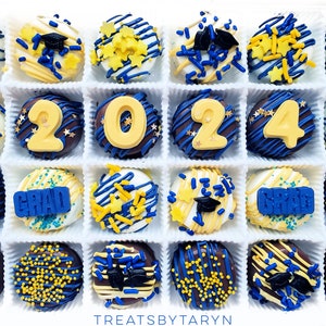 May include: A box of 16 chocolate-covered Oreos decorated with blue and gold sprinkles, graduation caps, and the words "GRAD" and "2024".
