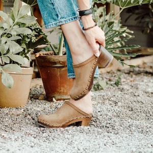 High heel studded clog mules with dexter tan brown nubuck leather and dark brown wooden base.