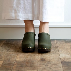 High heel studded clog mules with Olive green nubuck leather and dark brown wooden base.