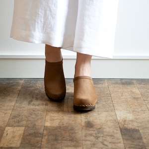 High heel studded clog mules with dexter tan brown nubuck leather and dark brown wooden base.