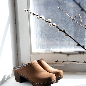 High heel studded clog mules with dexter tan brown nubuck leather and dark brown wooden base.