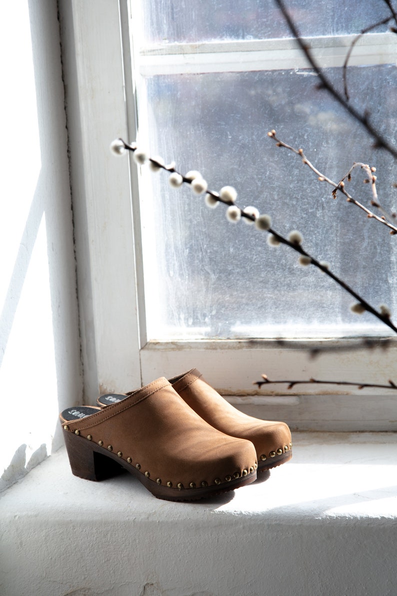 High heel studded clog mules with dexter tan brown nubuck leather and dark brown wooden base.