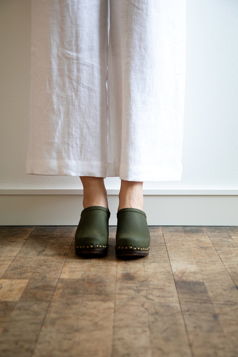 High heel studded clog mules with Olive green nubuck leather and dark brown wooden base.