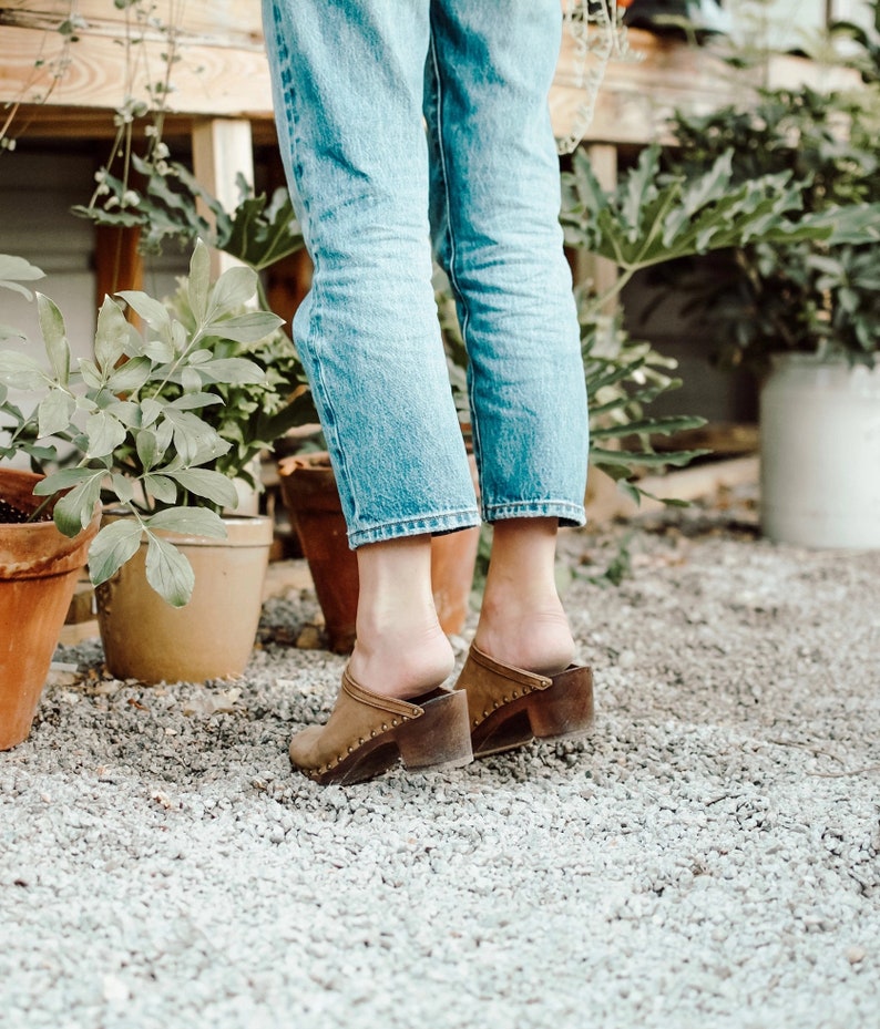 High heel studded clog mules with dexter tan brown nubuck leather and dark brown wooden base.