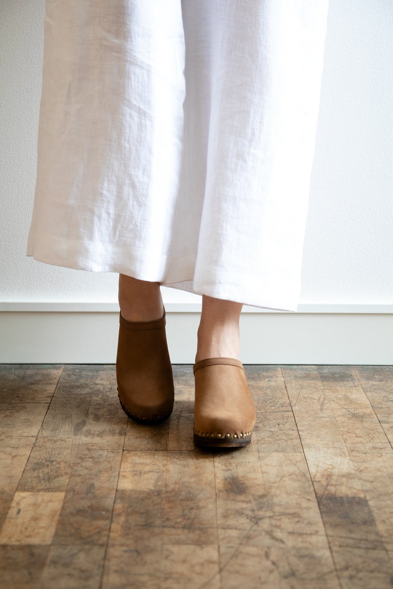 High heel studded clog mules with dexter tan brown nubuck leather and dark brown wooden base.