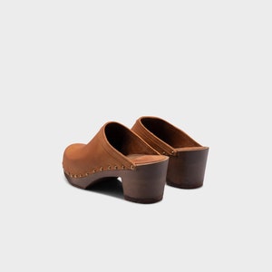 High heel studded clog mules with dexter tan brown nubuck leather and dark brown wooden base.