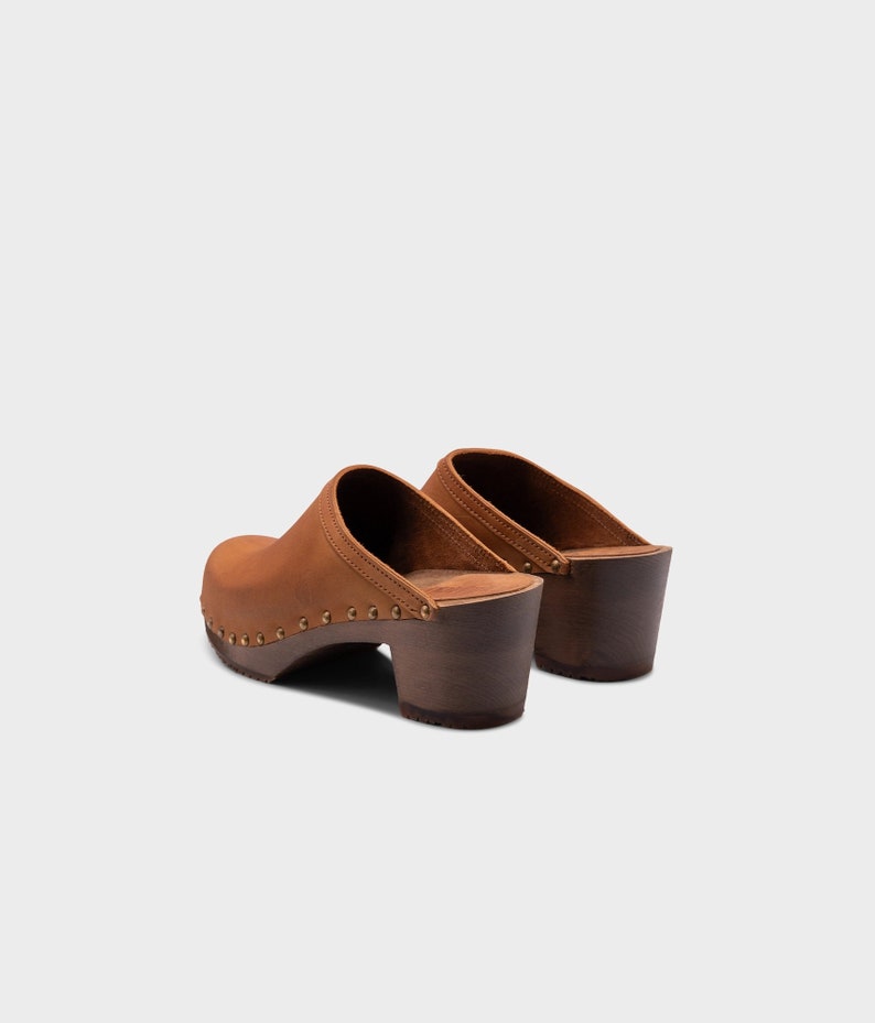 High heel studded clog mules with dexter tan brown nubuck leather and dark brown wooden base.