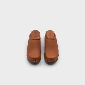 High heel studded clog mules with dexter tan brown nubuck leather and dark brown wooden base.