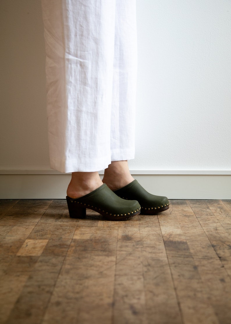 High heel studded clog mules with Olive green nubuck leather and dark brown wooden base.