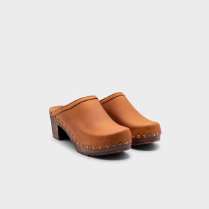 High heel studded clog mules with dexter tan brown nubuck leather and dark brown wooden base.