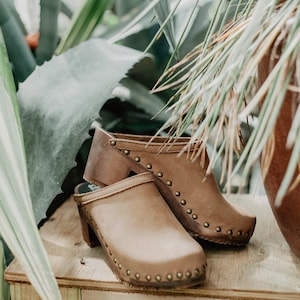 High heel studded clog mules with dexter tan brown nubuck leather and dark brown wooden base.