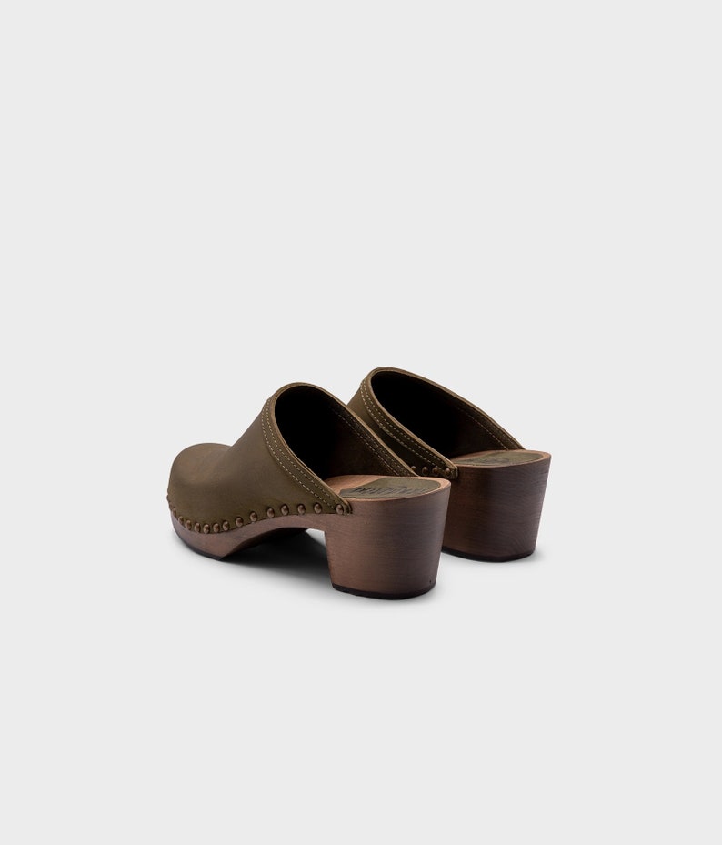 High heel studded clog mules with Olive green nubuck leather and dark brown wooden base.