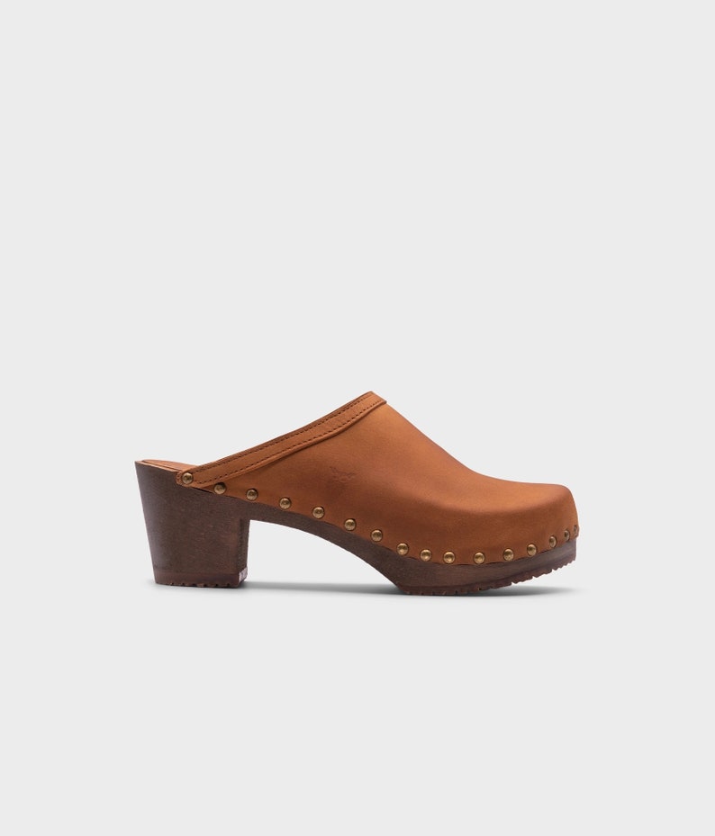 High heel studded clog mules with dexter tan brown nubuck leather and dark brown wooden base.