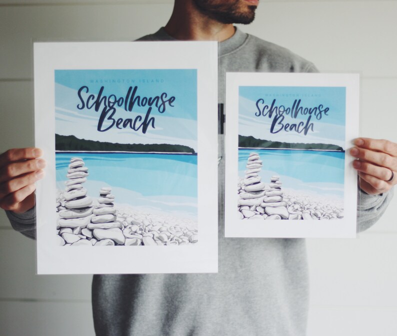May include: Two prints of a beach scene with a stone cairn in the foreground. The prints are titled "Schoolhouse Beach" and are in a retro style.