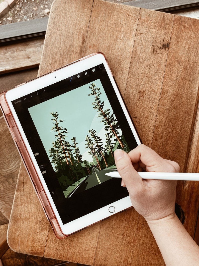May include: A digital illustration of a road through a forest on a tablet screen. A hand is holding a stylus and drawing on the screen.