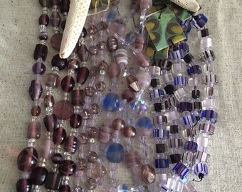 Purple bead assortment strand with pressed glass, acrylic, crystal and glass