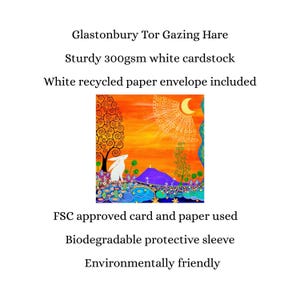 May include: A greeting card titled Glastonbury Tor Gazing Hare featuring a white hare in a colorful landscape with a purple hill, orange sky, and crescent moon. Made of 300gsm white cardstock, it includes a white recycled paper envelope.