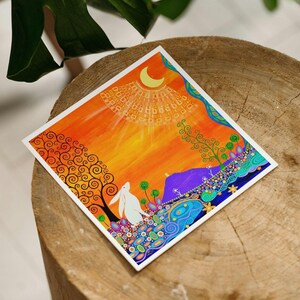 May include: A square art print featuring a white rabbit standing in a vibrant landscape with an orange sky, a yellow crescent moon, a dark tree with swirling branches, a purple mountain, and colorful floral patterns in blue, green, and pink.