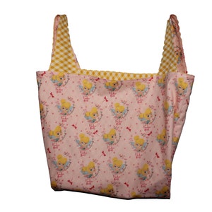 May include: A pink and yellow tote bag with a pattern of Tinker Bell fairies. The bag has a yellow and white checkered lining.