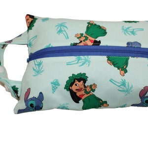 May include: A light blue zippered pouch with a handle. The pouch has a repeating pattern of palm trees, Stitch, and Lilo in a hula skirt.