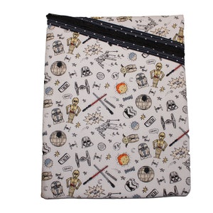 May include: A white fabric pouch with a black zipper and a black ribbon with white polka dots. The pouch is covered in a repeating pattern of Star Wars characters and objects, including Darth Vader, R2-D2, C-3PO, X-Wing fighters, and the Death Star.