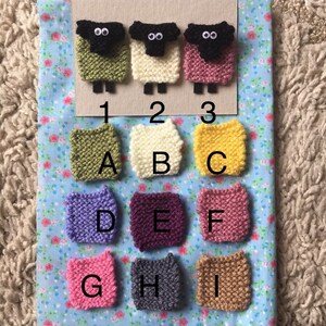 May include: Nine knitted squares in different colors, labeled A through I. Three knitted sheep figures are above the squares, labeled 1, 2, and 3.