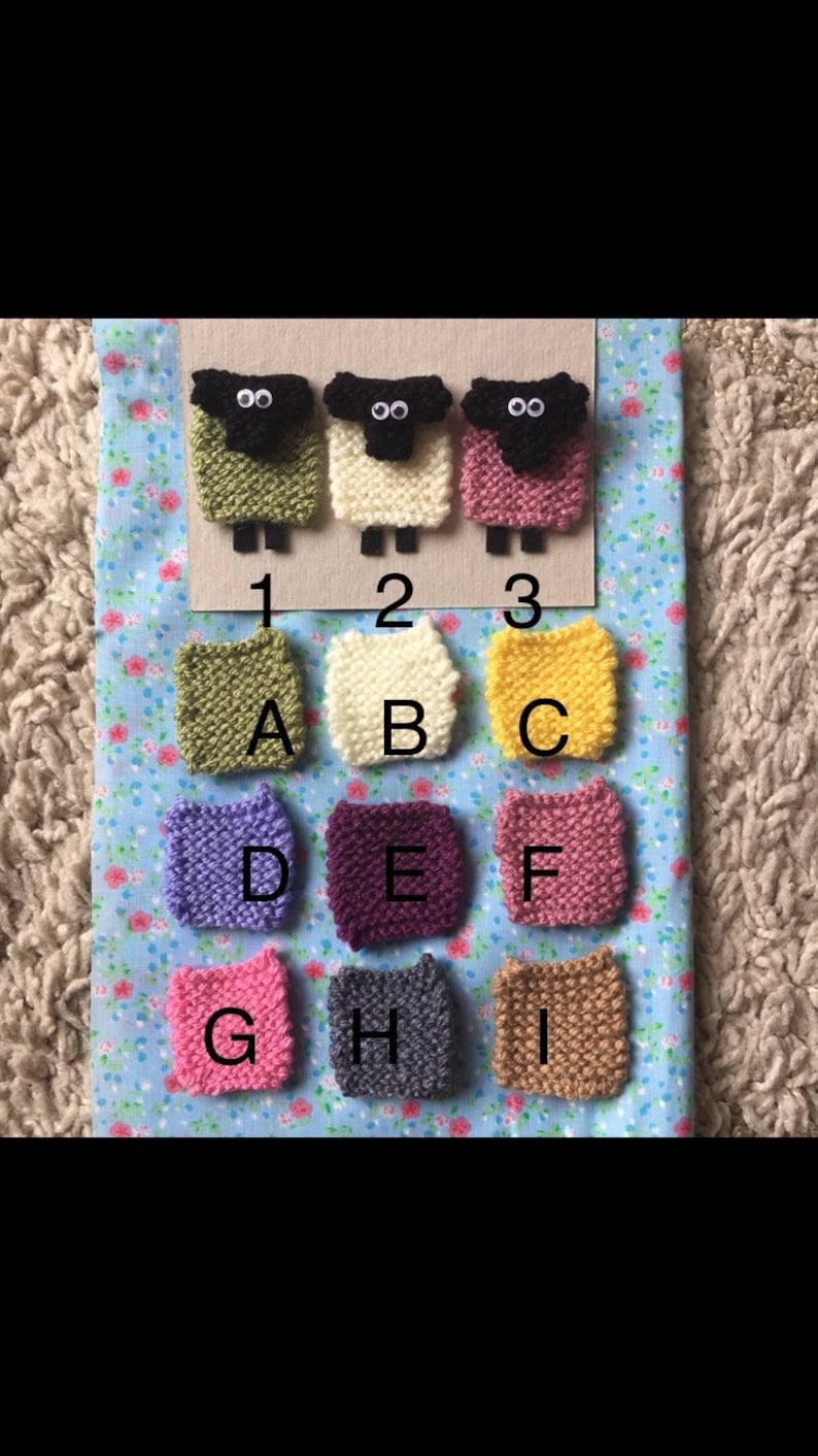 May include: Nine knitted squares in different colors, labeled A through I. Three knitted sheep figures are above the squares, labeled 1, 2, and 3.