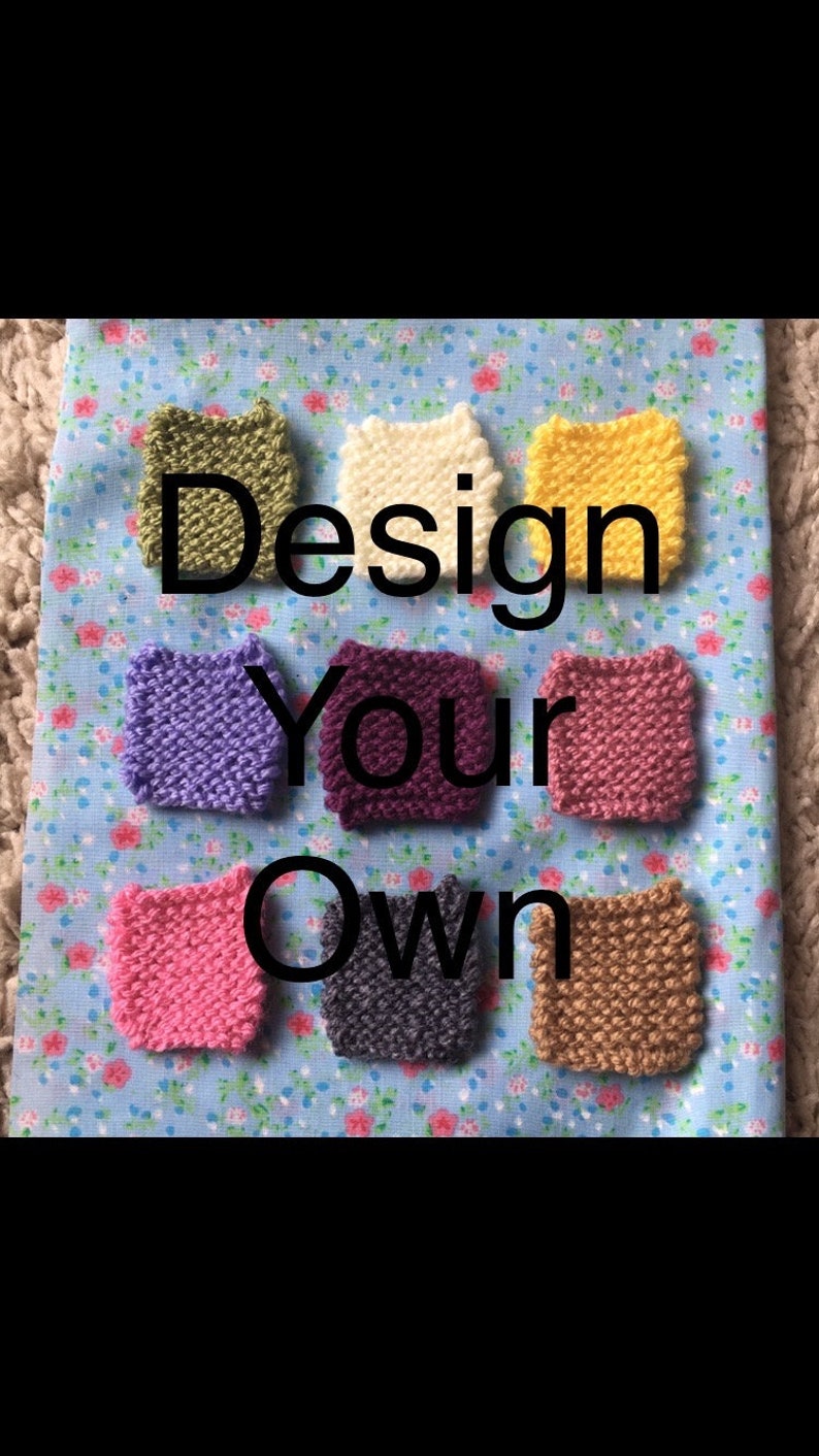 May include: Eight small knitted squares in different colors, including purple, pink, yellow, green, white, brown, and gray. The squares are arranged in a semi-circle on a blue and white floral fabric. The text "Design Your Own" is written in black letters above the squares.