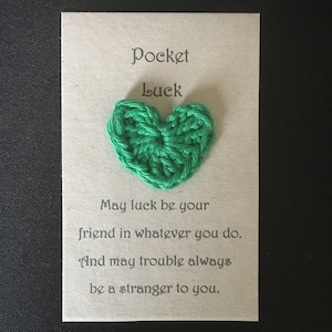 May include: A card with a green crocheted heart and the text "Pocket Luck" and "May luck be your friend in whatever you do. And may trouble always be a stranger to you."