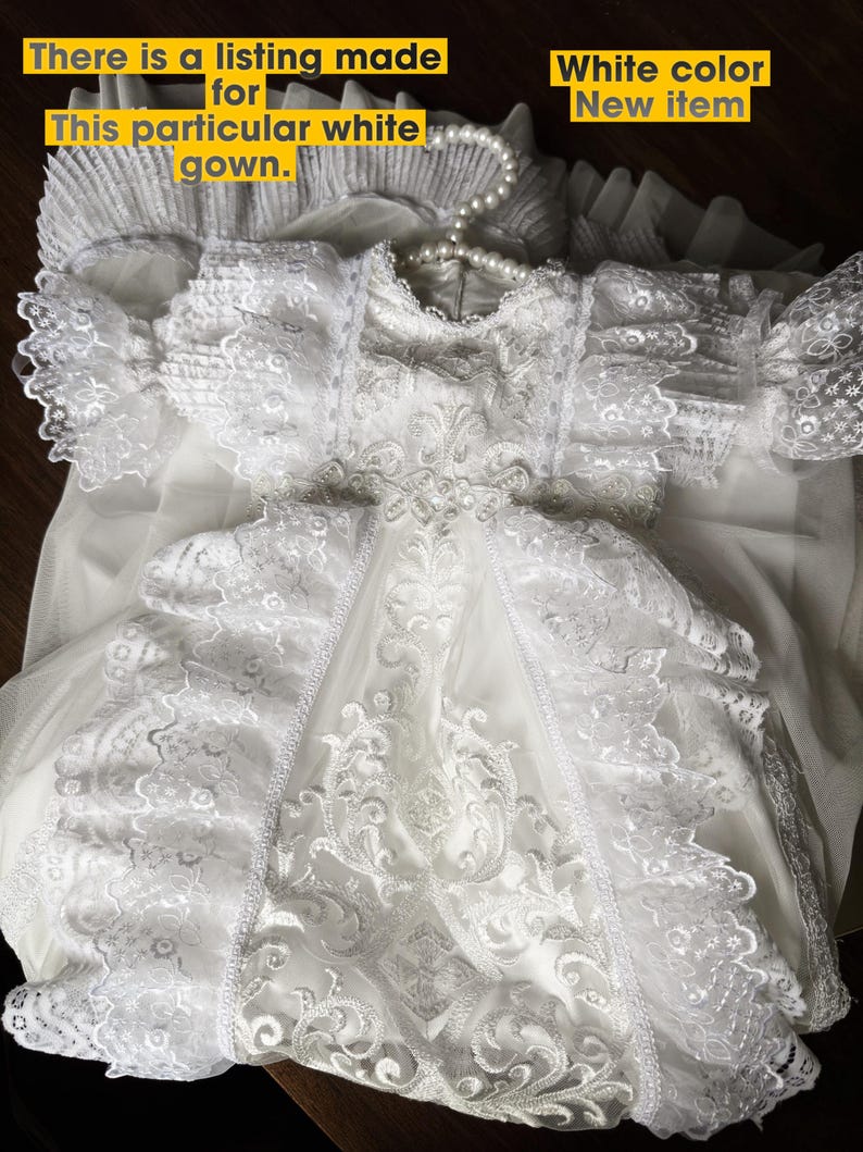 May include: A white gown with detailed lace and a pearl necklace. The gown has lace sleeves and a flowing skirt. The image text reads, "There is a listing made for This particular white gown."
