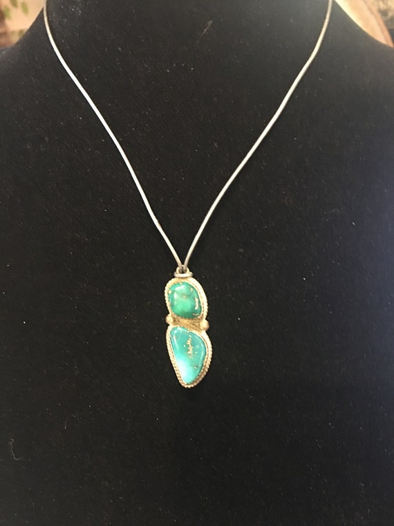 Turquoise navajo made pendant on thin leather