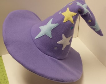 May include: A purple wizard hat with a pointed crown and a wide brim. The hat is decorated with colorful stars and sequins.
