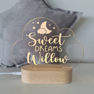 May include: A white acrylic cloud-shaped night light with a gold inscription that reads "Sweet Dreams Willow" and a crescent moon and stars design.