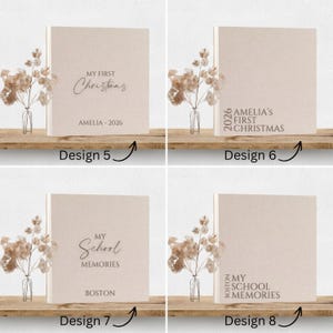 May include: Four square beige photo albums with linen-textured covers. Design 5 and 7 feature centered text, while 6 and 8 have left-aligned text. Each album is paired with a small glass vase containing dried foliage, labeled Design 5 through 8.