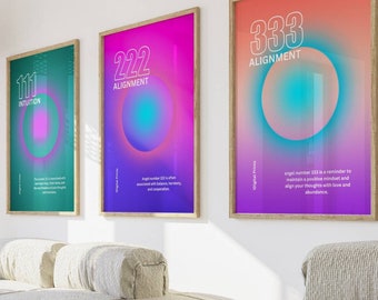 May include: Three framed posters with colorful gradients and white text. The posters feature the numbers 111, 222, and 333, with the words "Intuition", "Alignment", and "Alignment" below each number. The posters are hanging on a white wall in a living room setting.