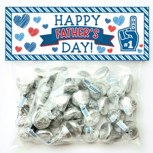Może przedstawiać: Drukowana etykieta prezentowa w kolorze niebieskim i czerwonym z tekstem "Happy Father's Day!" i niebiesko-białą ilustracją dłoni z tekstem "Dad #1".