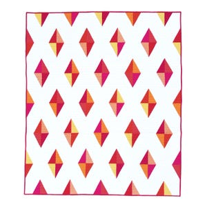 May include: A white quilt with a repeating pattern of colorful diamond shapes. The diamonds are composed of red, pink, orange, and yellow hues. The quilt has a magenta border.