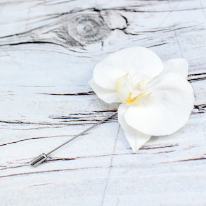 Flower lapel pin with white orchid.  Wedding flower boutonniere. Realistic tropical flower