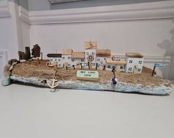 SEA VIEW LANE.chunky rustic driftwood,row off white cottages,shingle beach,sea groins,rocks,anchor,bike,and flags.coastal art,home decor.